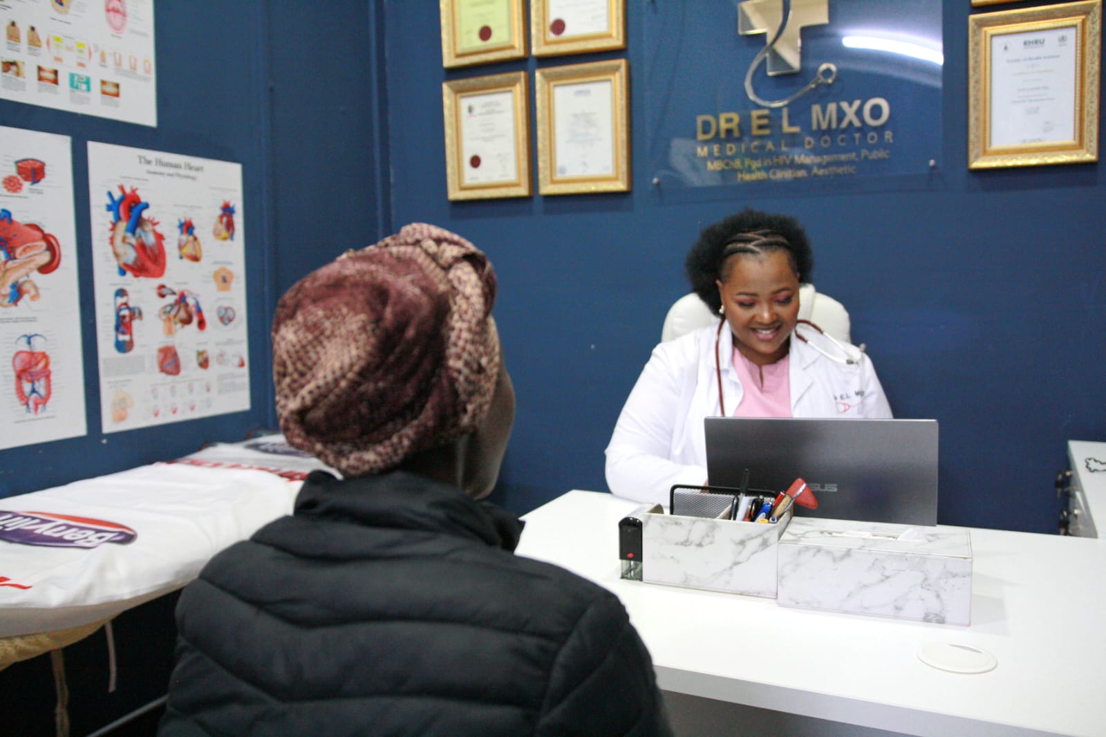 Dr Mxo speaking with a patient at her desk