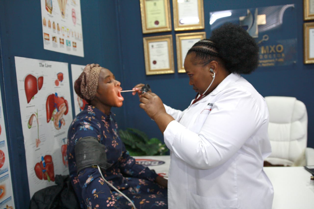 Dr Mxo examining a patient