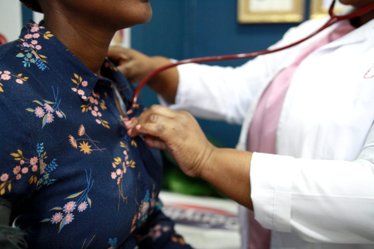 Dr E L Mxo examining a patient with a stethoscope